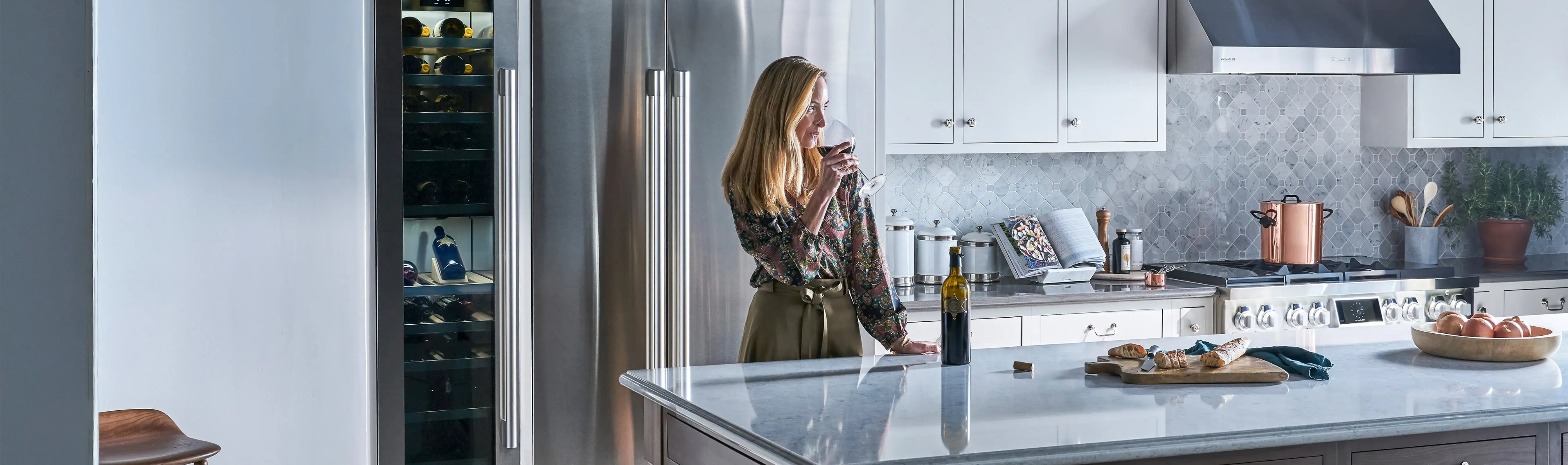 signature-kitchen-suite-woman-drinking-wine.jpg